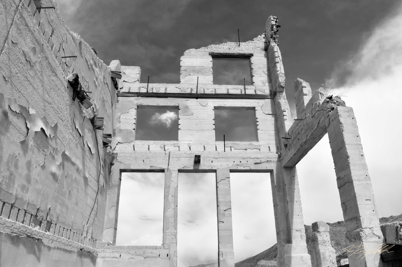 Black and white photograph of building ruins in Rhyolite, Nevada.
