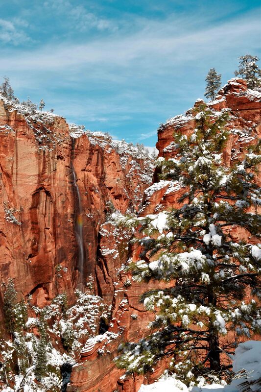 Photograph of snow and rainbow in Zion National Park.